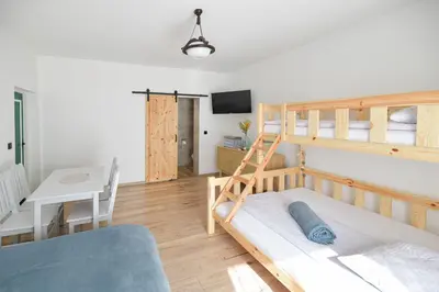 a bedroom with a bunk bed and a desk at Miętowe Zacisze Zator in Laskowa