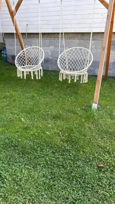 two swings in the grass in a yard at Mały biały domek Wadowice SPA jacuzzi sauna Gorzen blisko Wadowic in Gorzeń Dolny
