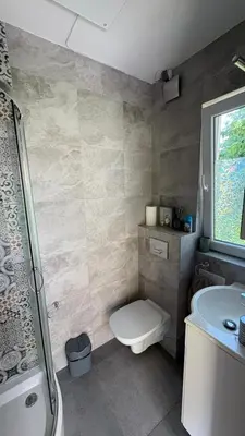 a bathroom with a toilet and a sink and a shower at Mały biały domek Wadowice SPA jacuzzi sauna Gorzen blisko Wadowic in Gorzeń Dolny