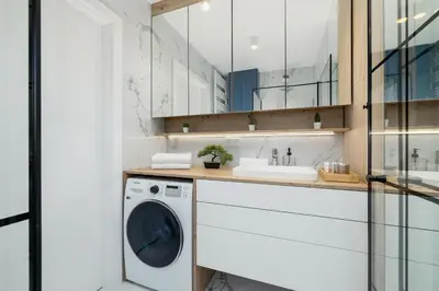 a laundry room with a washing machine and a sink at Elegant Studio Szpakowa 10 with 2 Parking Spaces & Terrace by Noclegi Renters in Kraków