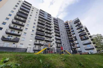 a large white apartment building with balconies on it at Elegant Studio Szpakowa 10 with 2 Parking Spaces & Terrace by Noclegi Renters in Kraków