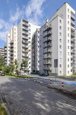 an empty street in front of tall buildings at Elegant Studio Szpakowa 10 with 2 Parking Spaces & Terrace by Noclegi Renters in Kraków
