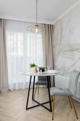 a dining room with a table and two chairs at Elegant Studio Szpakowa 10 with 2 Parking Spaces & Terrace by Noclegi Renters in Kraków