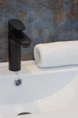 a black faucet on a toilet in a bathroom at Modern Apartment Podgorze with Parking by Noclegi Renters in Kraków