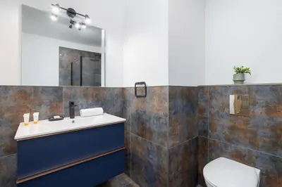 a bathroom with a sink and a toilet at Modern Apartment Podgorze with Parking by Noclegi Renters in Kraków
