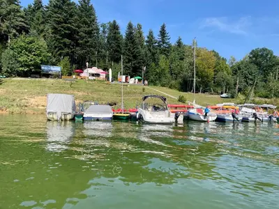 a group of boats docked in a body of water at Pod Gwiazdami in Dąbrówka