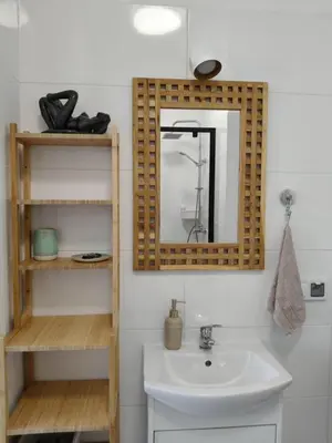 a bathroom with a sink and a mirror at Parrot's Apartment in Kraków