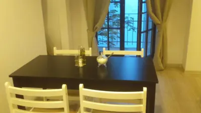 a dining room table with two chairs and a table and two windows at Words & Swords in Kraków