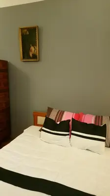 a bedroom with a bed and a couch and a window at Words & Swords in Kraków