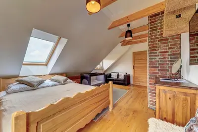 a bedroom with a bed and a brick wall at Domek w Górach z Balią in Zawoja