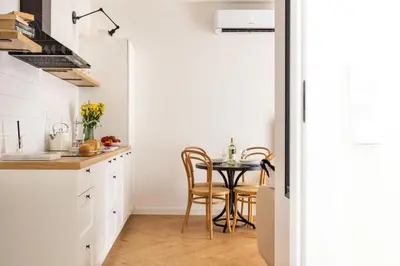 a small kitchen with a table and chairs at Canvas House Fragola Apartments - heart of Kazimierz in Kraków