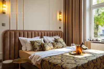 a bedroom with a large bed with a table at Canvas House Fragola Apartments - heart of Kazimierz in Kraków