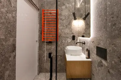 a bathroom with a sink and a glass shower at Canvas House Fragola Apartments - heart of Kazimierz in Kraków
