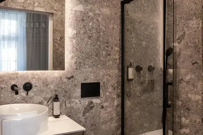 a bathroom with a sink and a shower at Canvas House Fragola Apartments - heart of Kazimierz in Kraków