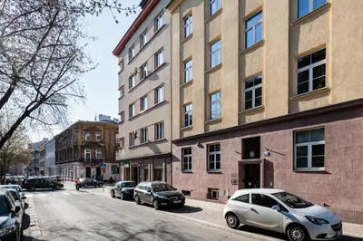 a white car parked on a street next to a building at Kraków Trailside Apartments - by Upstairs in Kraków