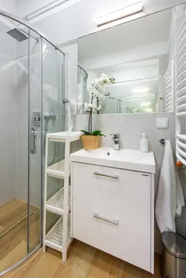 a bathroom with a white sink and a shower at Długa 14 by Homeprime in Kraków
