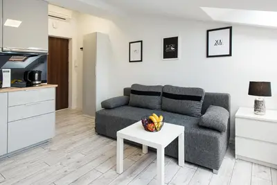 a living room with a couch and a table at Długa 14 by Homeprime in Kraków