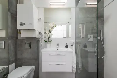 a bathroom with a sink and a toilet and a shower at Długa 14 by Homeprime in Kraków