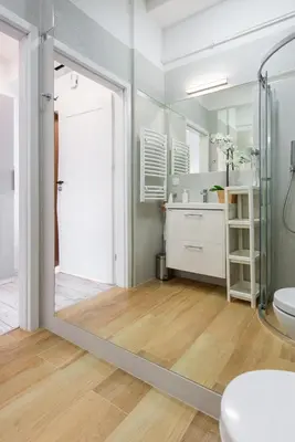 a bathroom with a shower and a toilet and a mirror at Długa 14 by Homeprime in Kraków