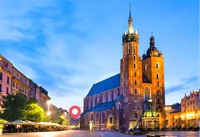 a large building with a clock tower on a street at City Center Studio with a View in Kraków