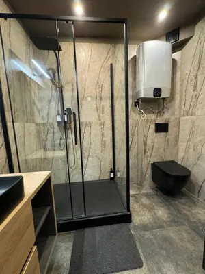 a bathroom with a shower with a toilet and a sink at City Center Studio with a View in Kraków