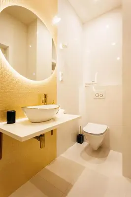 a bathroom with a sink and a toilet and a mirror at City of the Kings-Edith in Kraków