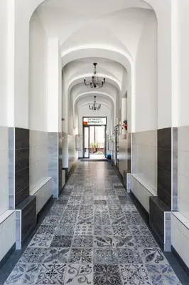 a hallway of a building with a tile floor at City of the Kings-Edith in Kraków