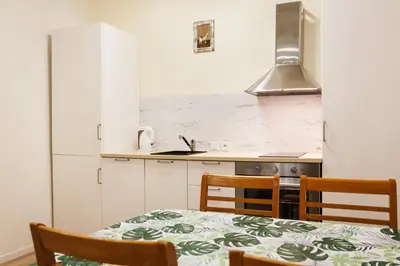 a kitchen with a table and chairs and a stove at City of the Kings-Edith in Kraków
