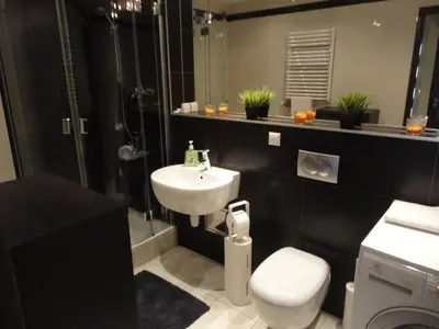 a bathroom with a sink and a toilet and a shower at Angel Plaza Krakow in Kraków