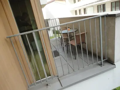 a balcony of a building with a table and chairs at Angel Plaza Krakow in Kraków