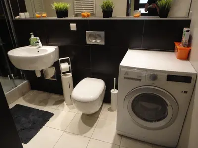 a bathroom with a washing machine and a sink at Angel Plaza Krakow in Kraków