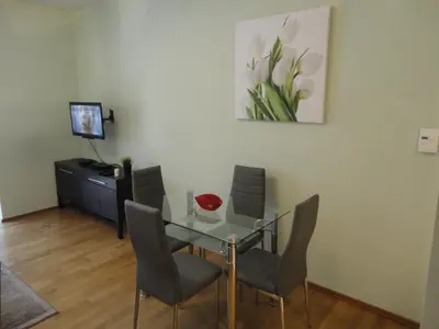a dining room with a glass table and chairs at Angel Plaza Krakow in Kraków