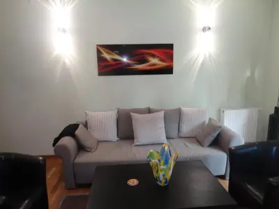 a living room with a couch and a table at Angel Plaza Krakow in Kraków