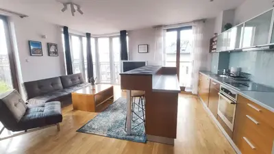 a kitchen with a desk and a living room at Starowiślna 52 by Homeprime in Kraków