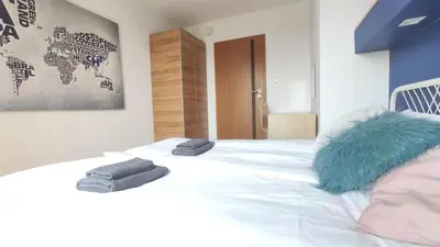 a bedroom with a bed with two towels on it at Starowiślna 52 by Homeprime in Kraków