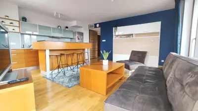 a living room with a couch and a kitchen at Starowiślna 52 by Homeprime in Kraków
