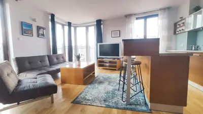 a living room with a couch and a television at Starowiślna 52 by Homeprime in Kraków