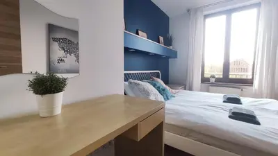 a bedroom with a large bed and a desk at Starowiślna 52 by Homeprime in Kraków