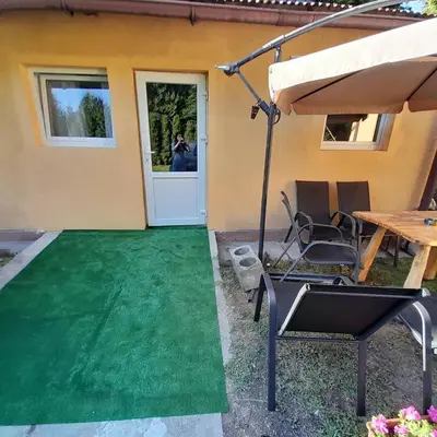 a house with a green lawn in front of a door at Domek Muchomorek 1km od Energylandii in Zator