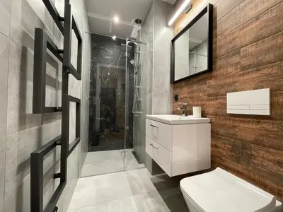 a bathroom with a toilet sink and a shower at Revesen Premium Apartments in Kraków
