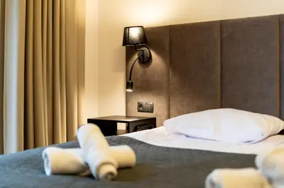a hotel room with a bed with towels on it at Revesen Premium Apartments in Kraków