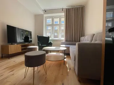 a living room with a couch and a table at Revesen Premium Apartments in Kraków