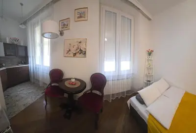 a small living room with a couch and a table at ViP APART CRACOW in Kraków
