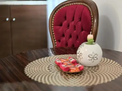 a table with a candle and two cookies on it at ViP APART CRACOW in Kraków