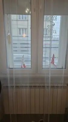 two windows in a room with some decorations on them at ViP APART CRACOW in Kraków