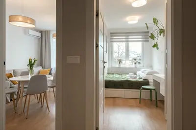 a bedroom and a living room with a bed and a table at Quiet Courtyard Apartment near Old Town in Kraków
