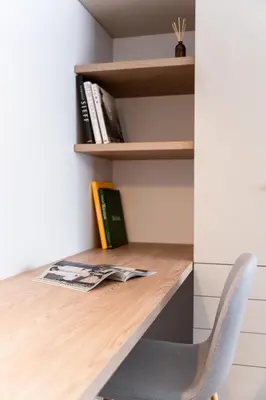 a desk in a room with a chair and books at Quiet Courtyard Apartment near Old Town in Kraków