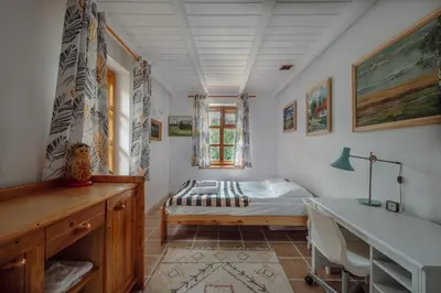 a bedroom with a bed and a desk in it at Willa Juszczyn in Juszczyn