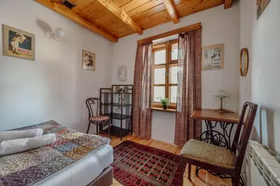 a bedroom with a bed and a desk and a window at Willa Juszczyn in Juszczyn