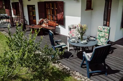 a patio with a table and chairs on a deck at Willa Juszczyn in Juszczyn